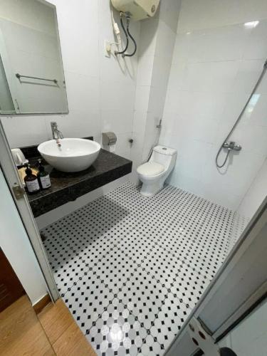 a bathroom with a sink and a toilet at HQ Hotel & Apartment in Hai Phong