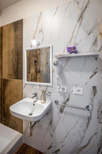 a white bathroom with a sink and a mirror at Florence Ventuno B&B in Florence