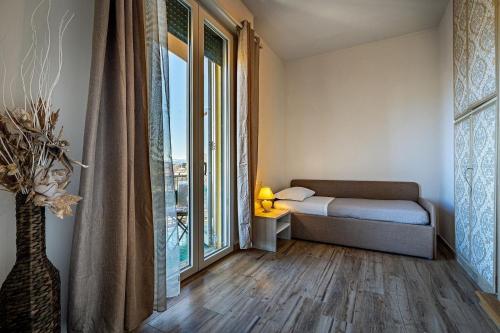 a bedroom with a bed and a large window at Florence Ventuno B&B in Florence