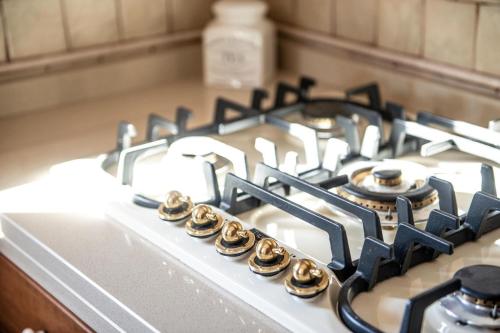 a close up of a gas stove top with its knobs at Tenuta Ulivi in Putignano