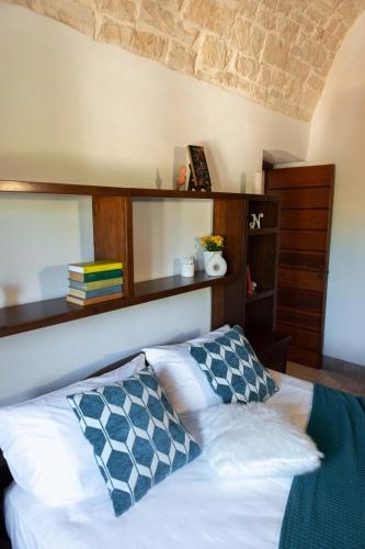 a bedroom with a bed with two pillows on it at Tenuta Ulivi in Putignano