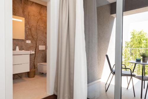 a bathroom with a white shower curtain and a table at Luxury house Natanel in Škrip