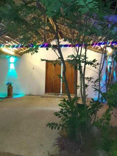 a room with a tree in front of a building at Rock Hill in Tanamalwila