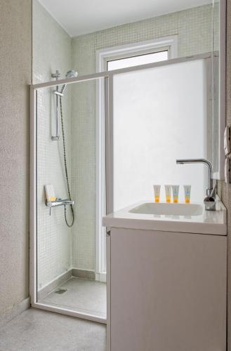 a bathroom with a sink and a shower at VESTA - Heliopolis Residence in Cairo
