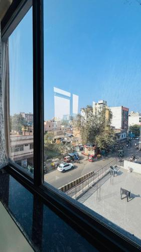 a window with a view of a city street at Hotel Vivaanta in Dhanbād