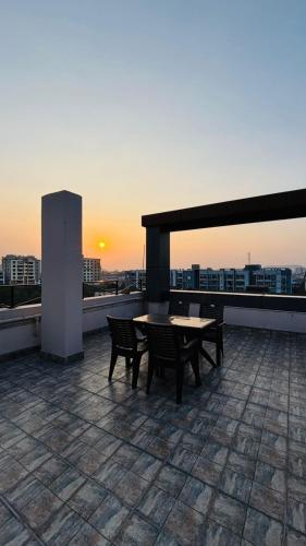 a patio with a table and chairs on a roof at Hotel Vivaanta in Dhanbād