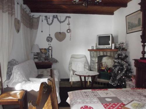 a living room with a christmas tree and a couch at gite au creux de la Vallée in Brezons