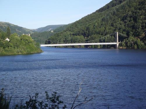 a bridge over a large body of water at gite au creux de la Vallée in Brezons