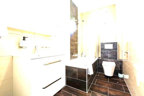 a bathroom with a sink and a toilet at Maison de Maître in Tramelan