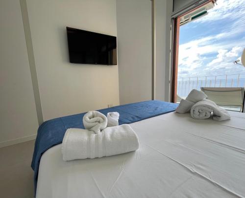 a bedroom with a bed with towels on it at Tigullio Blue Experience - Portofino Luxury View in Villa Solari