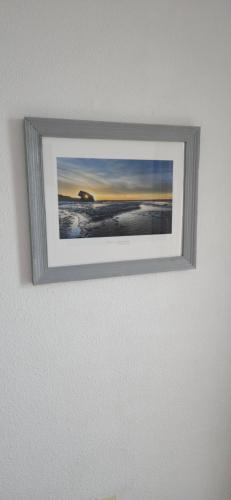 a picture hanging on a wall in a room at Vue & Détente in Cayeux-sur-Mer