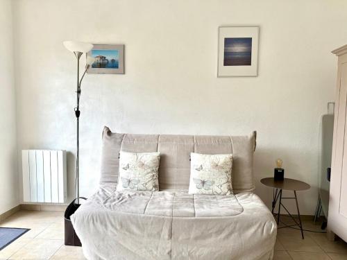 une chambre avec un lit blanc avec deux oreillers dans l'établissement Appartement studio centre Arcachon 4 pers terrasse, à Arcachon