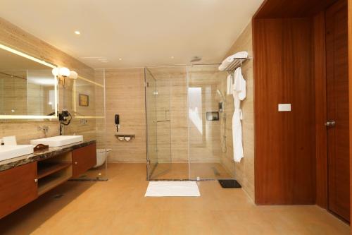 a bathroom with a glass shower and a sink at Tree of Life Amara Resorts & Spa, Udaipur in Udaipur