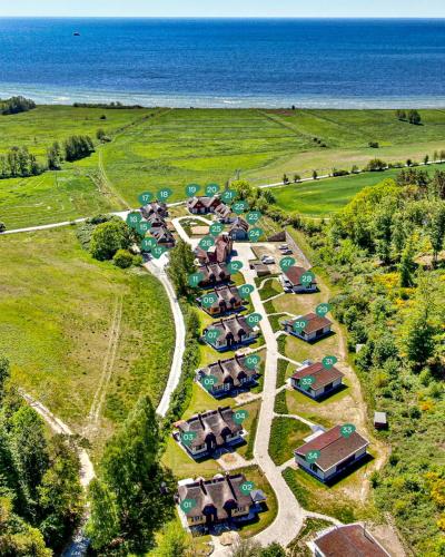 an aerial view of a resort with the ocean at Ferienhaus Sehnsuchtsort 04 Feriendorf Klein Stresow Rügen by ruyastay in Putbus