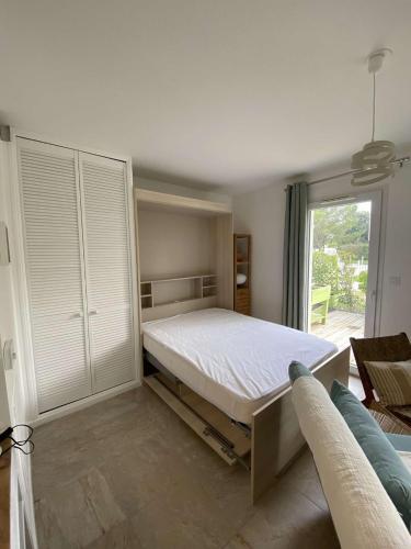 une chambre avec un lit et une grande fenêtre dans l'établissement Studio LA ROCHELLE - LR740-001, à La Rochelle