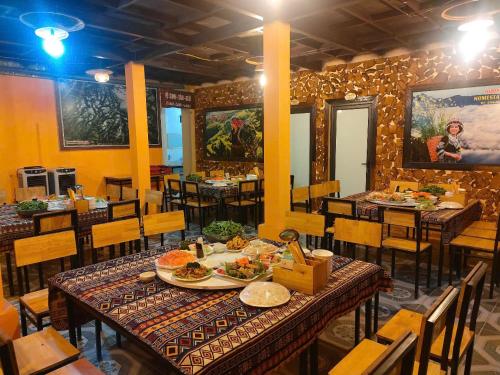 a restaurant with tables and chairs with food on them at Nhà hàng Homestay Hương Tây Bắc in Trạm Tấu