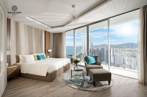 a hotel room with a bed and a large window at Moonlight Bay Panorama Condotel Ocean View in Nha Trang