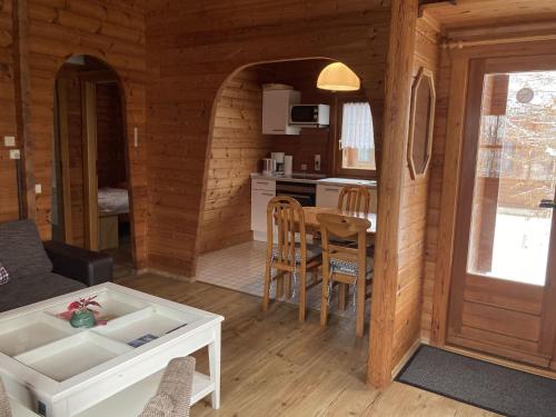 a living room and kitchen of a log cabin at Hasselhäuser Hasselhaus 4 in Hasselfelde