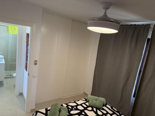 a room with a light and two chairs and a curtain at Castillo Sol Bungalow in Caleta De Fuste