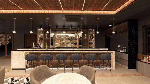 a bar with blue bar stools in a restaurant at Tree of Life Amara Resorts & Spa, Udaipur in Udaipur