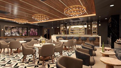a restaurant with tables and chairs and a bar at Tree of Life Amara Resorts & Spa, Udaipur in Udaipur