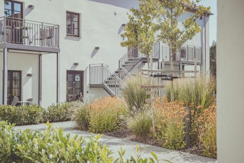 a courtyard of a building with stairs and plants at Mariandl im Oberwirt in Eggenfelden