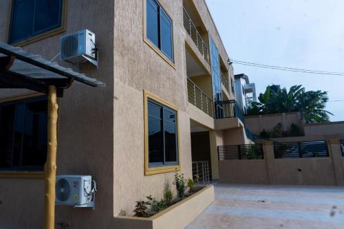 a apartment building with a balcony and a window at Agape Villa Apartment in Sekondi-Takoradi