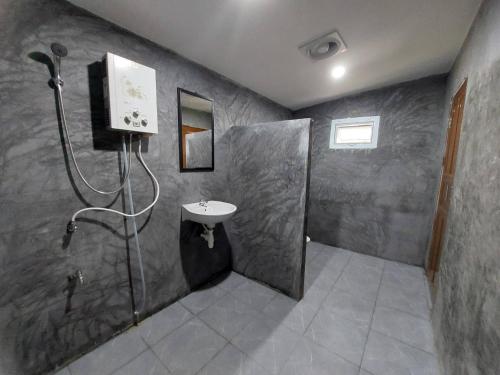 a bathroom with a sink and a shower at Ploy&Praew House 3 in Ban Sop Mae Klang