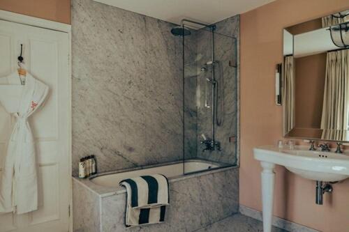 a bathroom with a sink and a shower and a sink at Oakley Court in Windsor