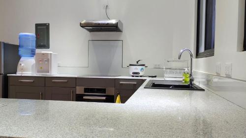 a kitchen with a sink and a counter top at Ormoc Mountain View Apartment in Ormoc