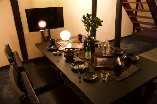 a table with a bottle of wine and glasses on it at 飛騨の宿唯 in Takayama
