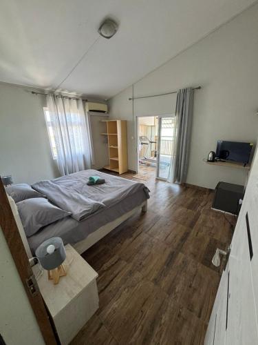 a bedroom with a large bed and a wooden floor at Horizon Lodge in Diamond Island