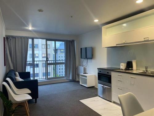 a kitchen and living room with a view of a apartment at Aura C two bedrooms apartment balcony good view wi-fi easy parking in Auckland