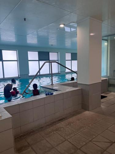 a group of people in a swimming pool at Aura C two bedrooms apartment balcony good view wi-fi easy parking in Auckland