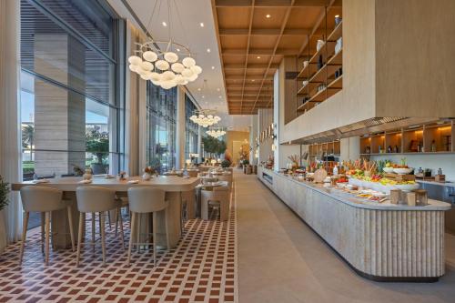 a restaurant with a bar with stools in the middle at Vida Dubai Mall in Dubai