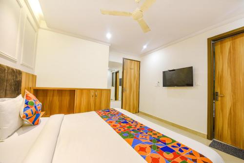 a bedroom with a bed and a flat screen tv at FabHotel Midway in Amritsar