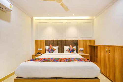 a bedroom with a large bed with colorful pillows at FabHotel Midway in Amritsar