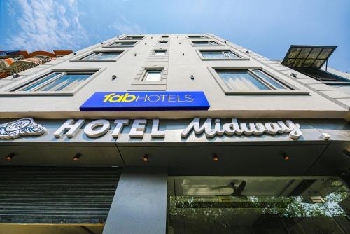 a hotel with a sign on the side of a building at FabHotel Midway in Amritsar