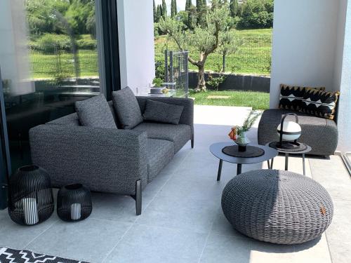 a living room with a couch and two tables at Villa LagoBlu in Costermano sul Garda