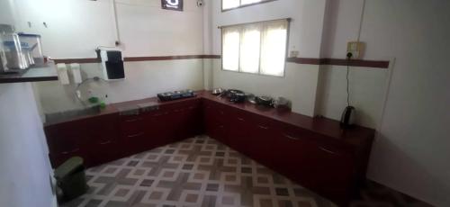 a room with a bathroom with a sink and a window at Hazarika's Home in Jorhāt