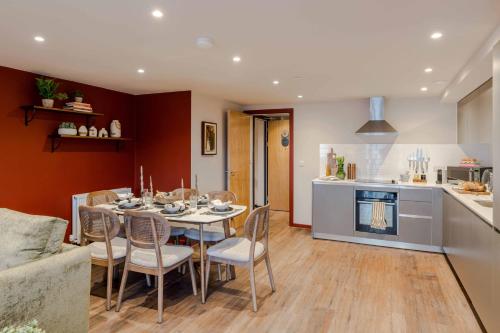 a dining room and kitchen with a table and chairs at Waterside Living I Luxe Apartments in Bristol