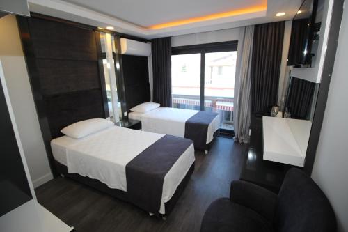 Postel nebo postele na pokoji v ubytování avsa extra vagant hotel
