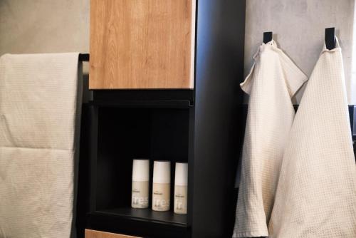 a black shelf in a bathroom with towels at Panorama Chalet Ehrwald in Ehrwald