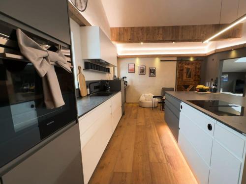a kitchen with white cabinets and a black counter top at Panorama Chalet Ehrwald in Ehrwald
