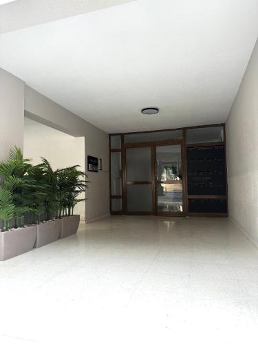 an empty hallway with potted plants in a building at Melia Suites in Limassol