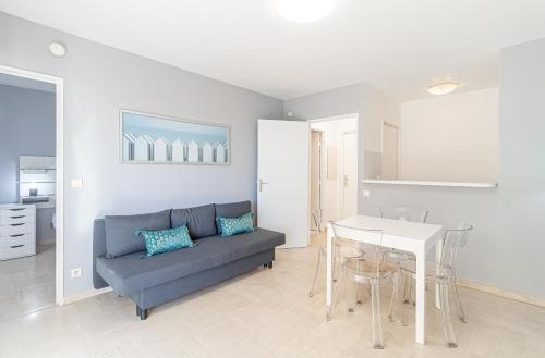 un salon avec un canapé et une table dans l'établissement 1 Room Apartment 1 Minute From Monaco, à Beausoleil