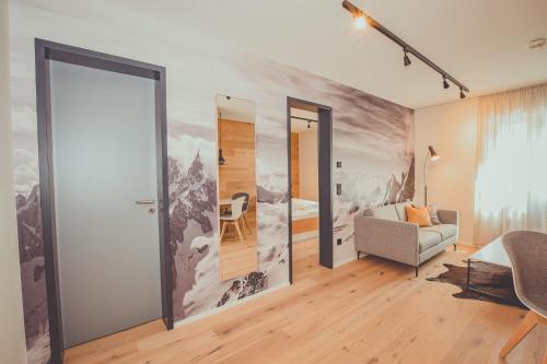 a living room with a wall mural of a mountain at Mariandl im Oberwirt in Eggenfelden