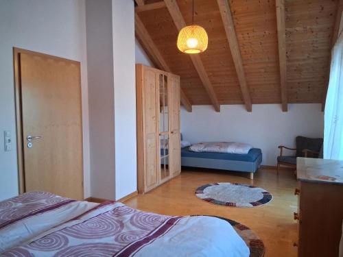 a bedroom with a bed and a couch in a room at Haus Schönbrunner in Hohenau