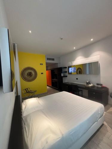 a bedroom with a white bed and a desk at Blue Shades Hotel in Pisa