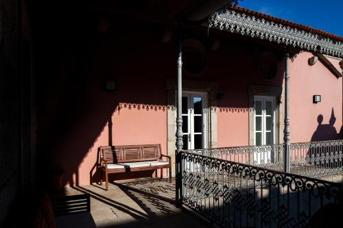 a bench sitting on a balcony of a building at Casas Novas Countryside Hotel Spa & Events in Chaves